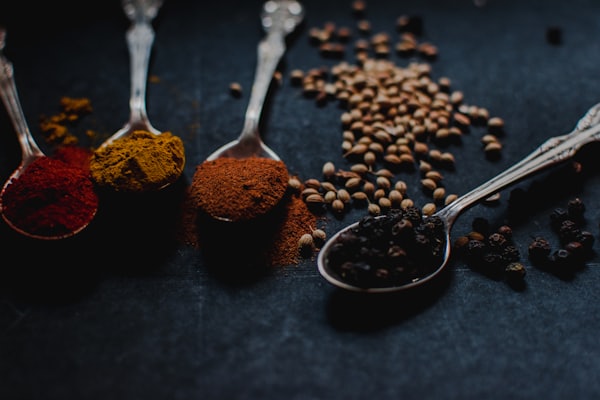 Spice powders on silver spoons